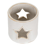 Overhead angled view into the candle holder, showing its speckled interior and star-shaped openings on opposite sides.