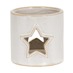 Cream-white cylindrical candle holder viewed slightly from above, showing a tan-edged star opening and open rim.