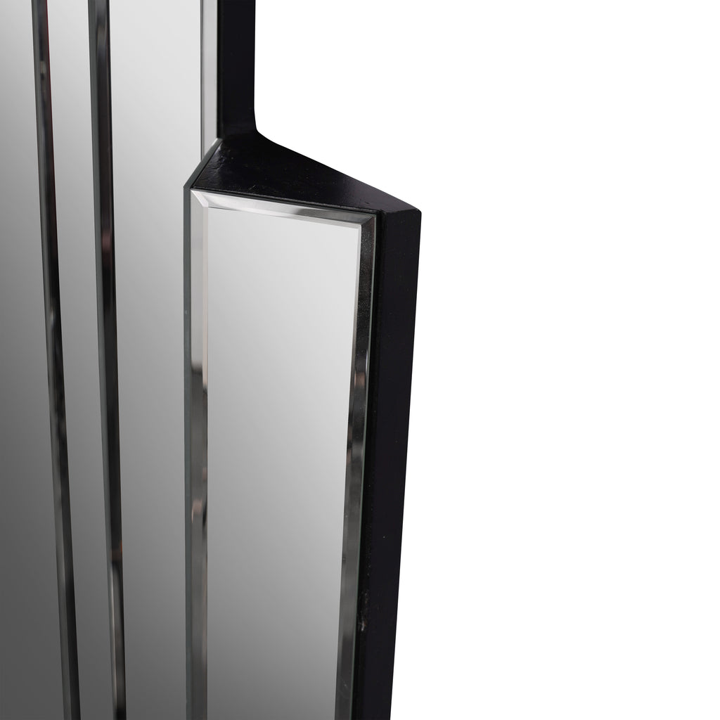 Close-up of a projecting mirror panel with a bevelled border and black painted top and side surfaces.