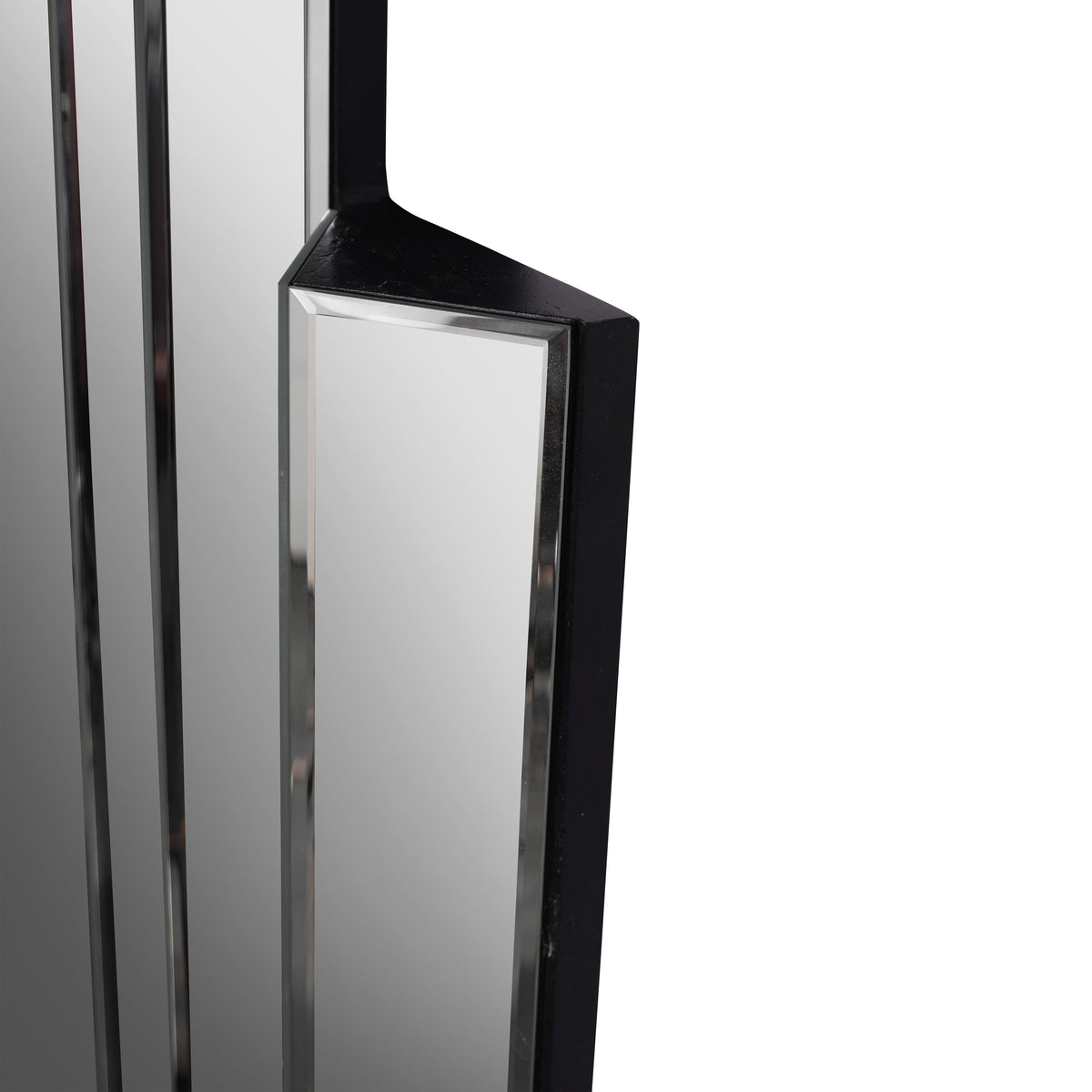Close-up of a projecting mirror panel with a bevelled border and black painted top and side surfaces.