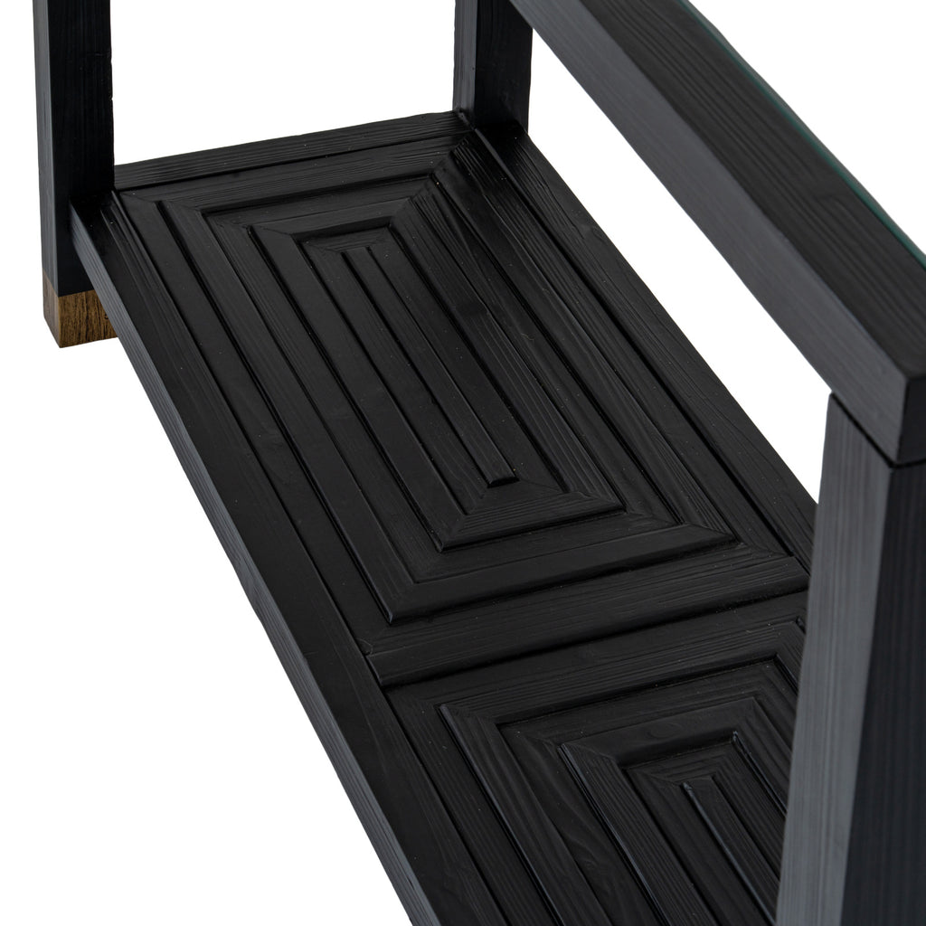 Close-up of concentric raised rectangles on the console table's black lower shelf, with a gold-toned leg cap at the left.