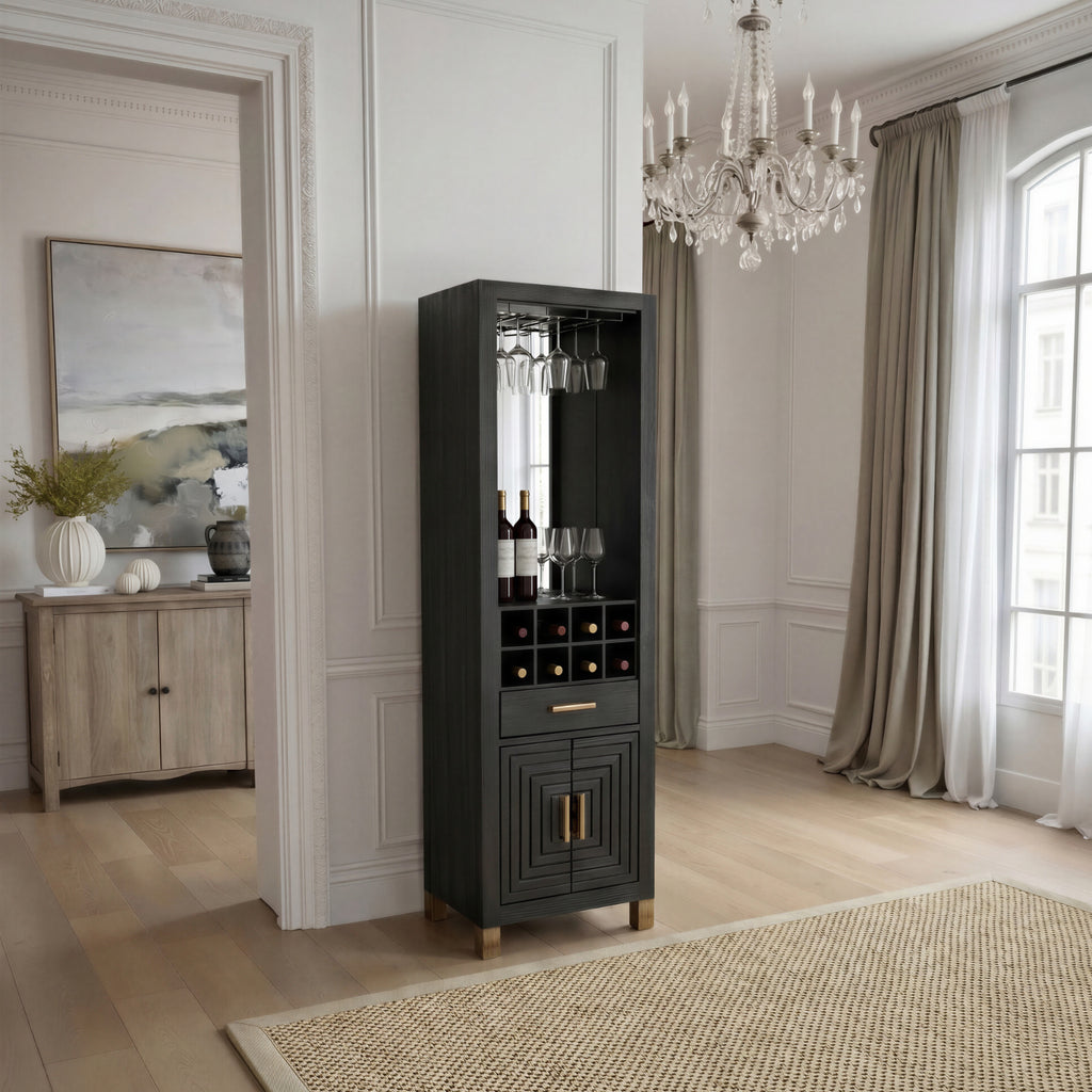 Black drinks cabinet styled with bottles and glasses in a pale panelled room beside an open doorway, with curtains and a chandelier.