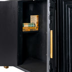 Sideboard detail with a door open, revealing a dark interior and a shelf styled with books beside the patterned front and brass-toned handle.
