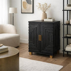 Black stepped-pattern cabinet styled with a vase, branches and books beside a cream chair and black shelving in a pale living room.