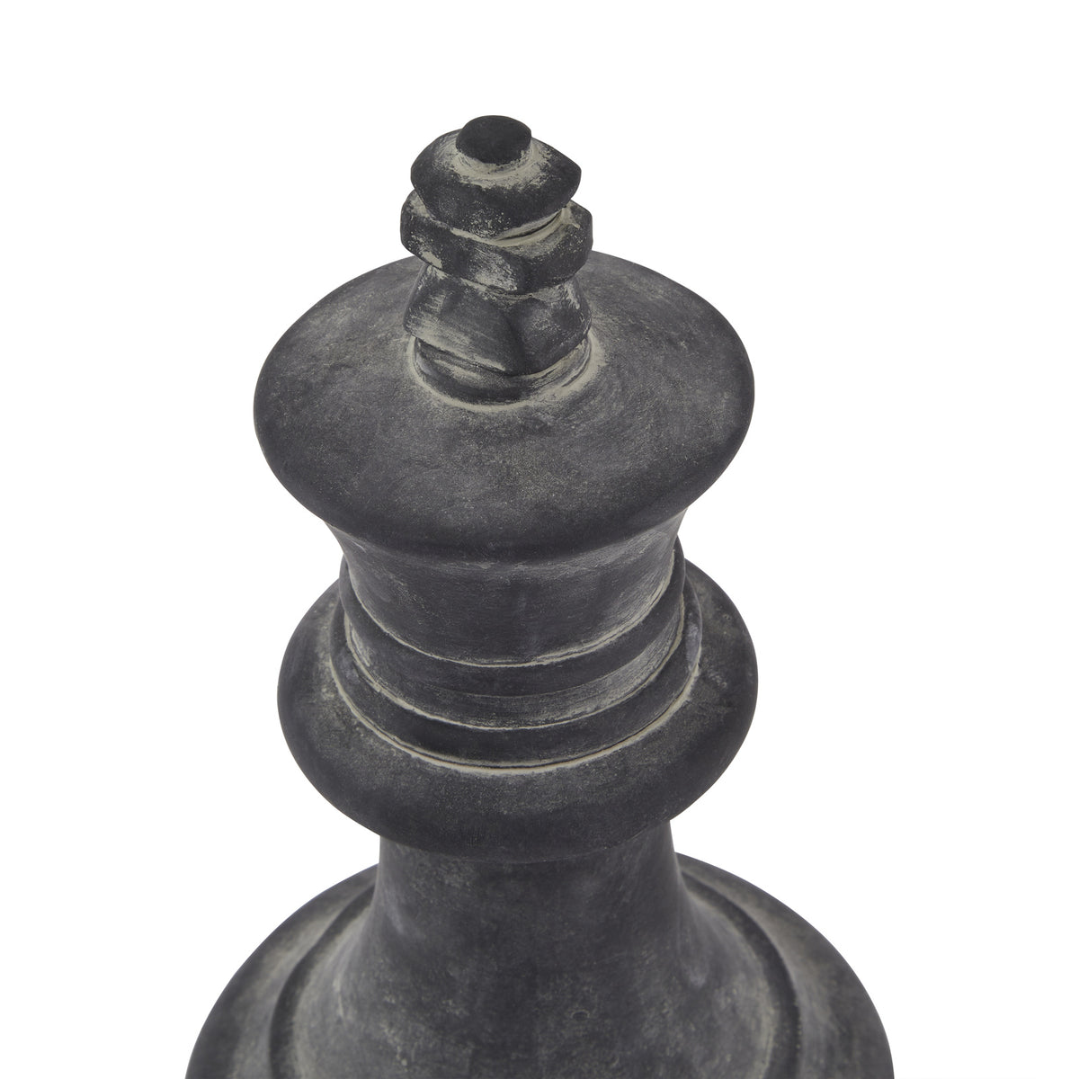 Angled close-up of the king ornament's stacked finial, flared crown and ringed collar, showing pale grey mottling across the dark surface.