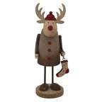 Front view of a rustic reindeer decoration with pale antlers, a red cap and nose, three red buttons and a spotted stocking, standing on a round base.