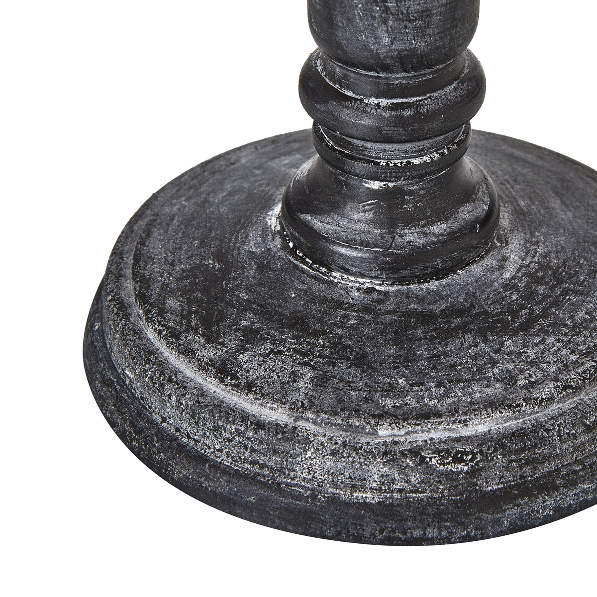 Close-up of the lamp's broad circular foot and lower column, with pale highlights across the dark textured finish.
