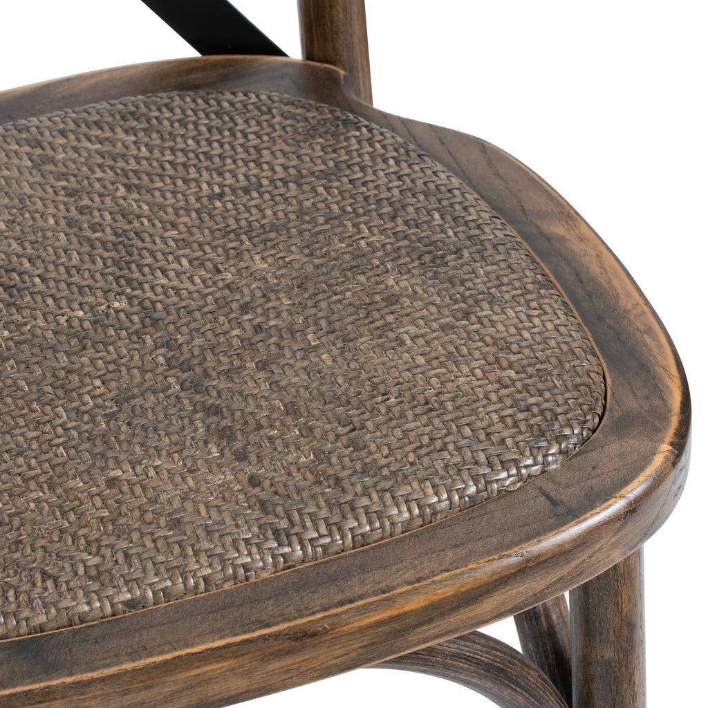 Close-up of the brown woven seat surface and rounded grain-patterned seat frame on the Strapcross Dining Chair.