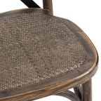 Close-up of the brown woven seat surface and rounded grain-patterned seat frame on the Strapcross Dining Chair.