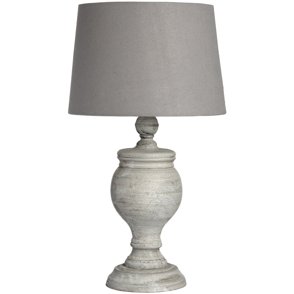Striated Urn Table Lamp with a pale grey textured urn base, stepped foot and gently tapered neutral shade against white.