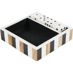 Angled view of a black, white and brown striped tray with a dark interior and four white dice in a narrow compartment.