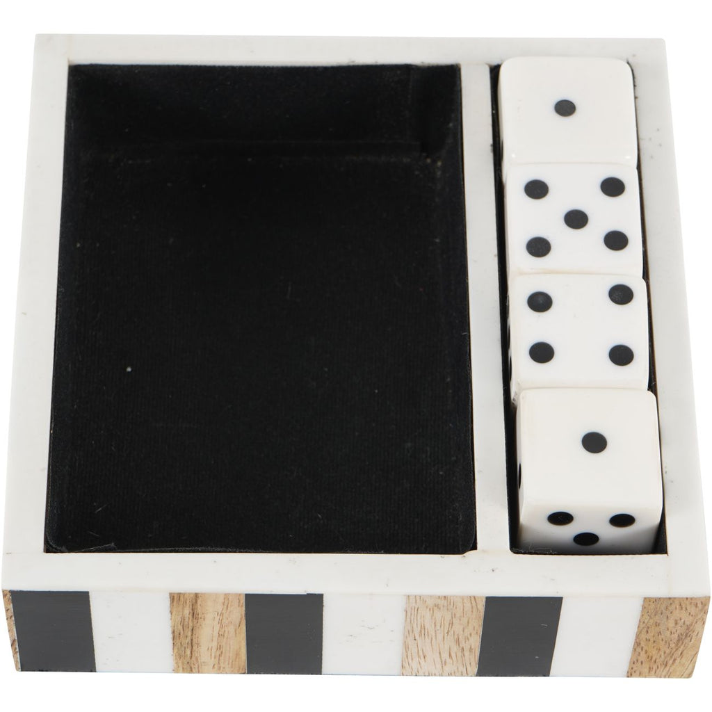 View from above of the divided tray, showing its empty dark main compartment and four white dice arranged along one side.