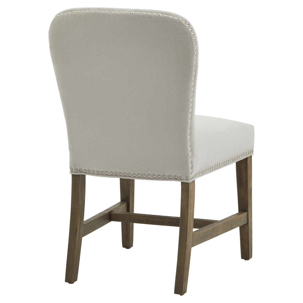 Rear three-quarter view of the dining chair, with round studs outlining the pale grey back and brown wood-grain detailing beneath the seat.