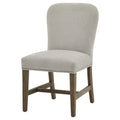 Front three-quarter view of the pale grey dining chair, showing its curved back, bright studs along the seat edge and brown legs with H-shaped stretchers.