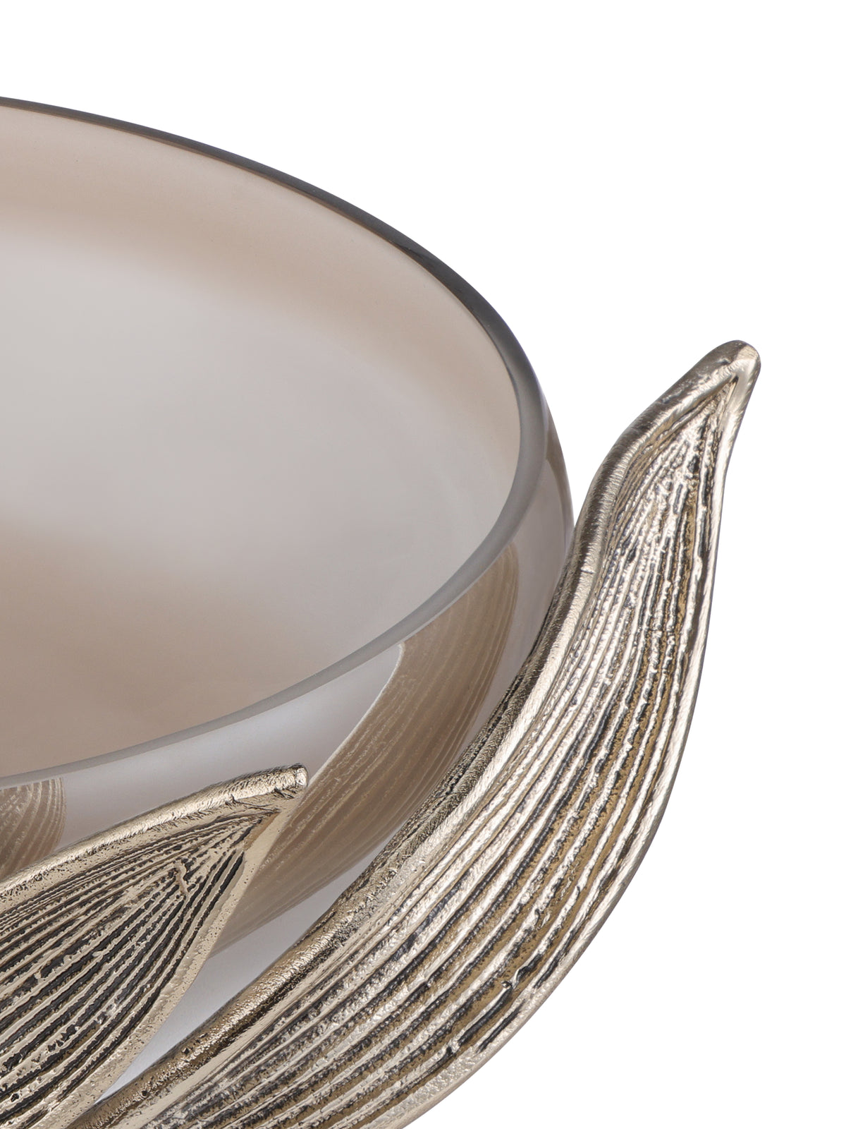 Close view from above of the glass rim and the fine ribbed texture on the curved gold leaves.