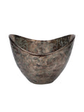 Bronze-toned decorative bowl on a white background, with a dipping curved rim and mottled green detailing inside and out.