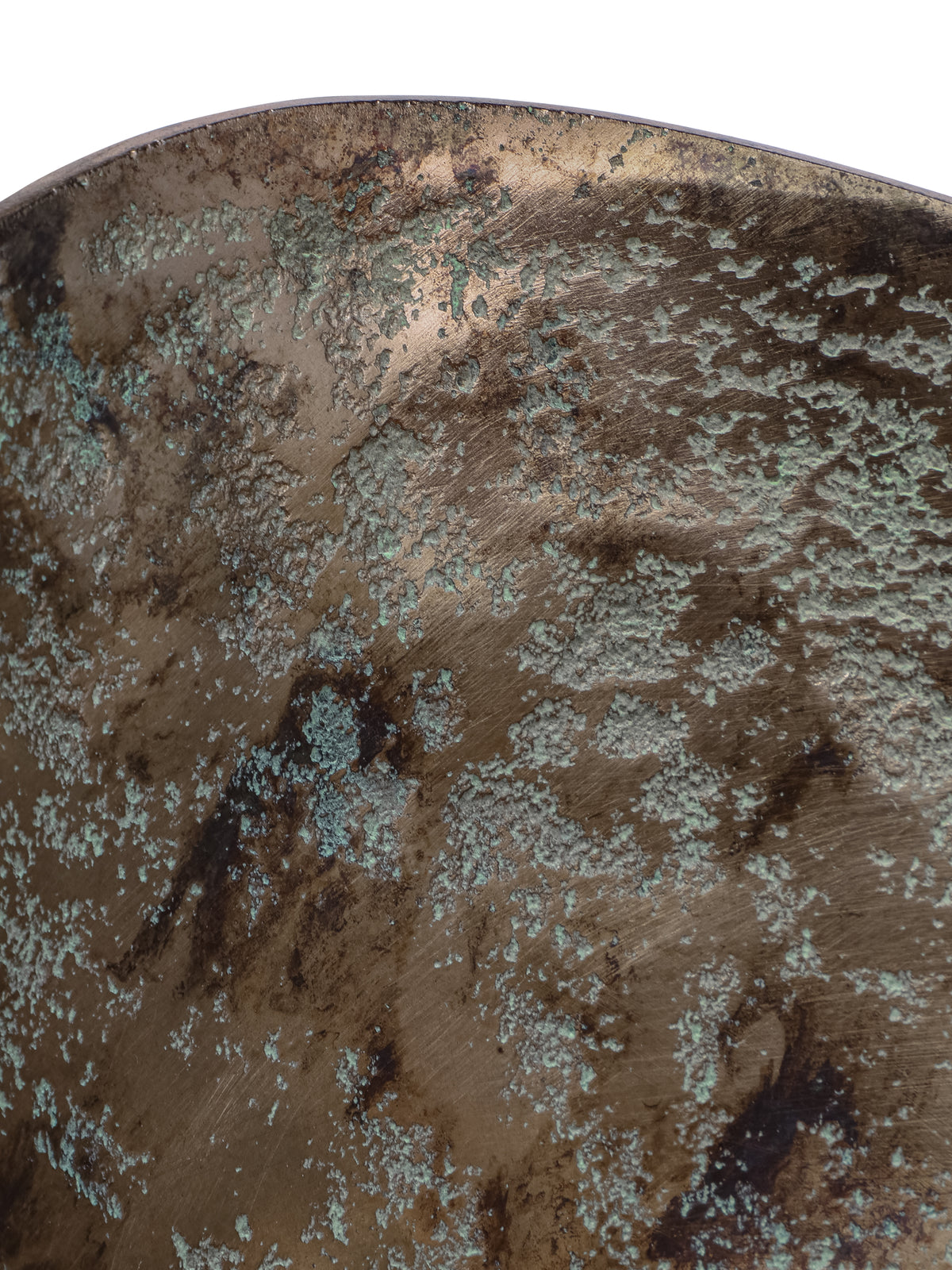 Close-up of the bowl's interior and curved rim, with textured green detailing over a dark bronze-toned surface.