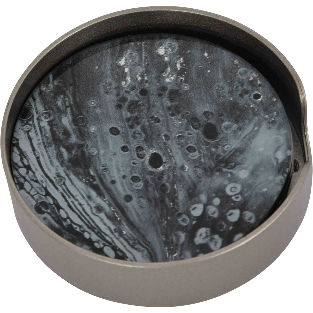 Close angled view of a Swirl coaster inside its round silver-toned holder, showing the charcoal and grey patterned face.