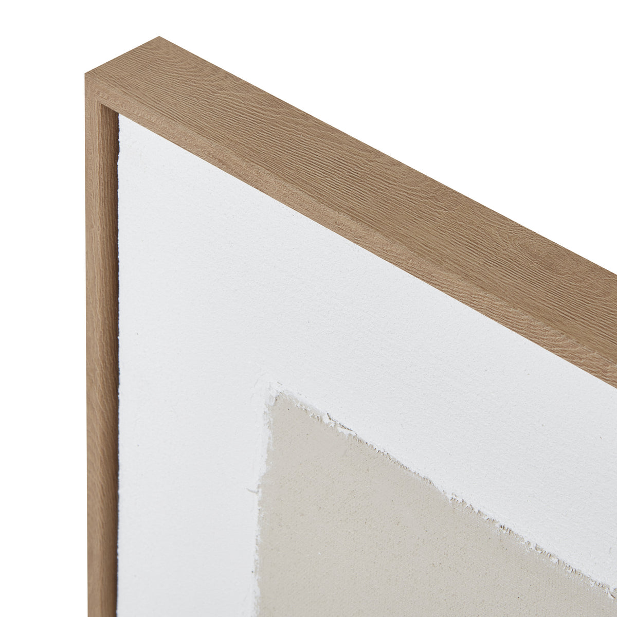 Close-up of the upper frame corner with its brown grain pattern beside the white border and rough edge of a cream panel.