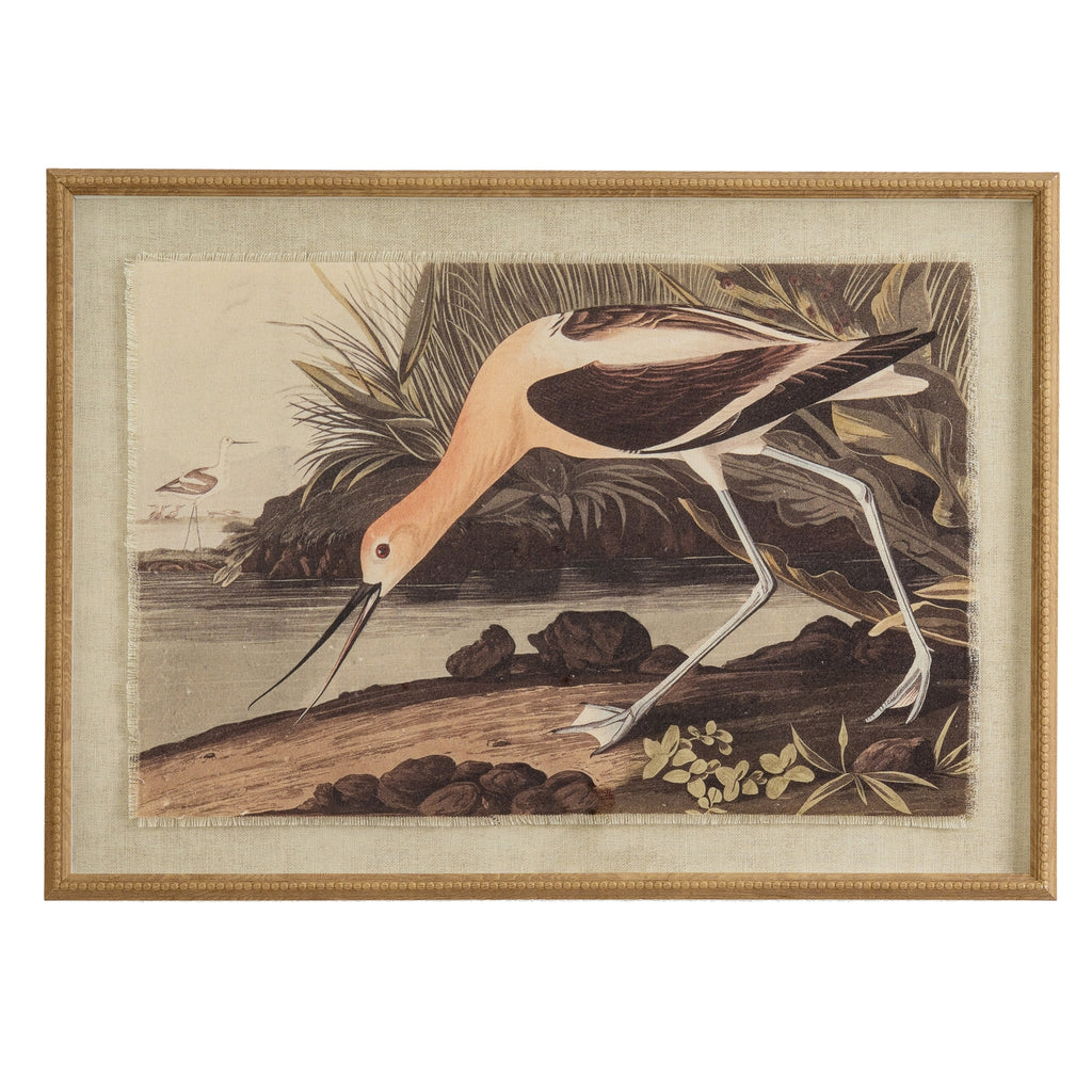 Landscape framed print of a pale and dark long-legged bird bending beside the water, with a smaller bird in the distance and a tan-gold border.