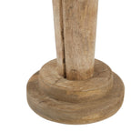 Detail of the divided legs meeting the two-tier round base, with linear markings across the brown surface.
