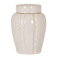 Pale cream lidded jar with a broad cylindrical cap, rounded shoulders and fine tan wavy lines down its glossy-looking body against a white background.