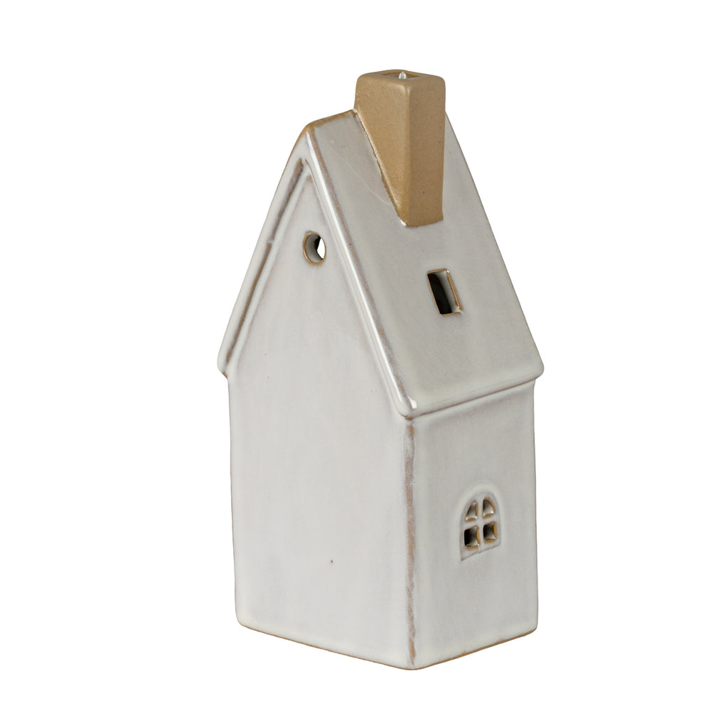 Rear and side view of the cream-white townhouse decoration, showing the plain rear wall, circular gable opening, tan chimney and small framed side window.