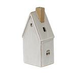 Rear and side view of the cream-white townhouse decoration, showing the plain rear wall, circular gable opening, tan chimney and small framed side window.