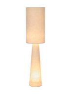 Floor lamp switched on, with warm light glowing through the cylindrical linen shade and tapered fabric body.