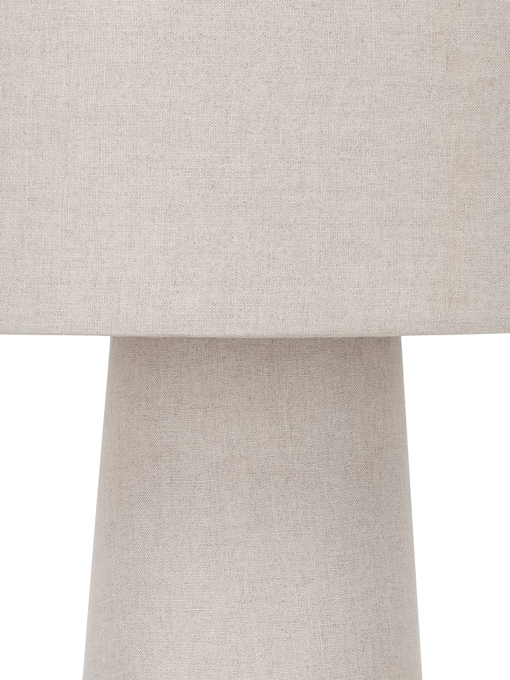 Close-up of the woven linen texture where the cylindrical shade meets the narrower top of the tapered body.