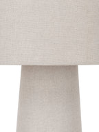 Close-up of the woven linen texture where the cylindrical shade meets the narrower top of the tapered body.