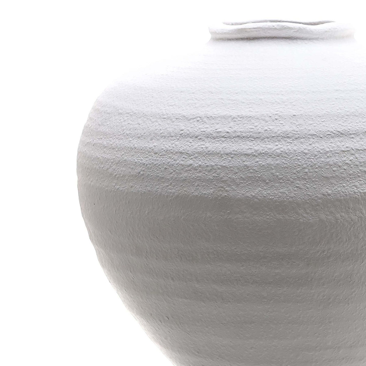 Close-up of the white vase showing its rough, subtly banded surface and irregular opening.