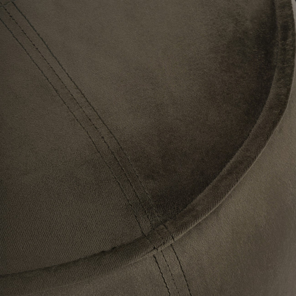 Detail of the green velvet-textured top showing double stitching meeting the curved piped edge.