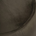 Detail of the green velvet-textured top showing double stitching meeting the curved piped edge.