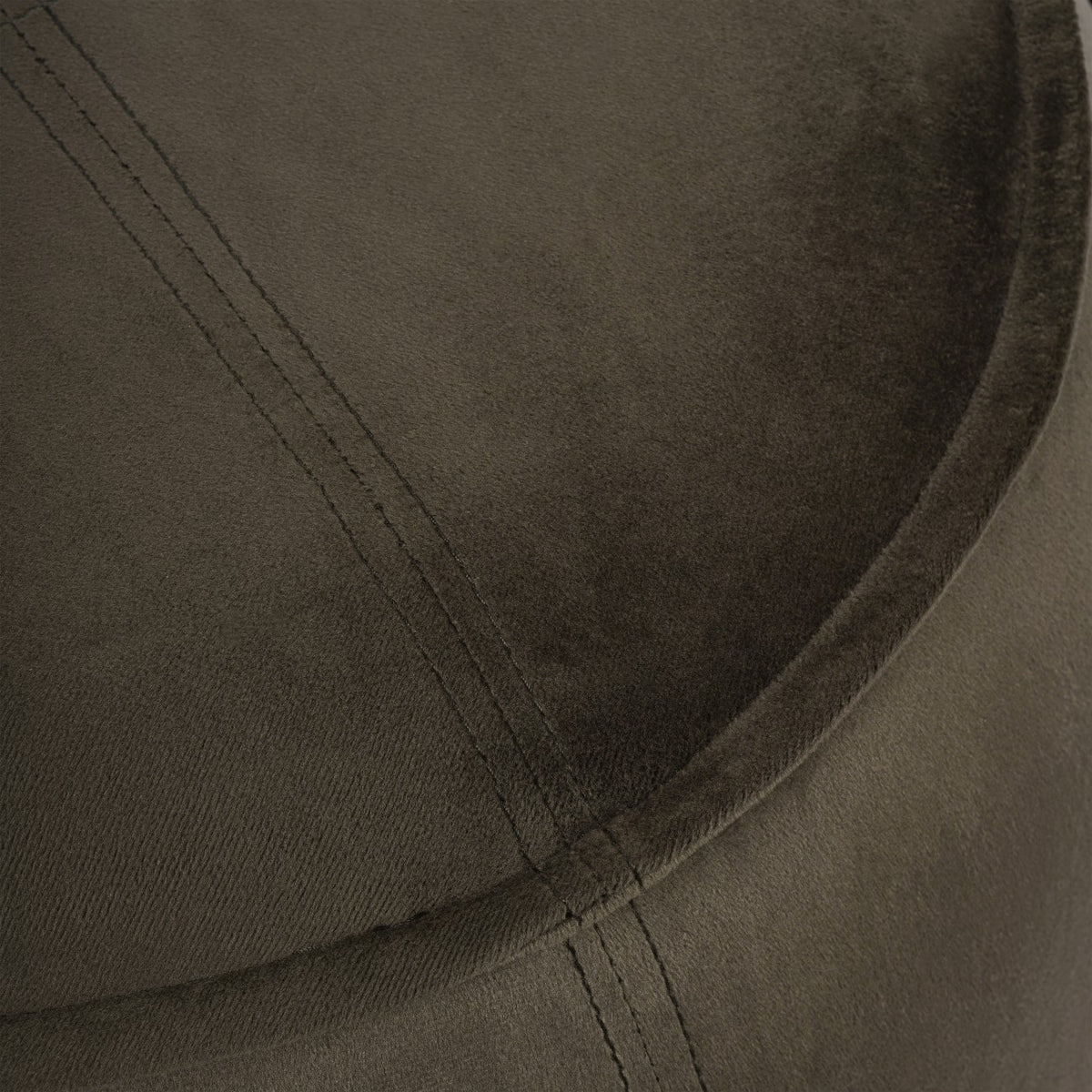 Detail of the green velvet-textured top showing double stitching meeting the curved piped edge.