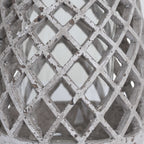 Close-up of the lantern's criss-cross lattice, with grey and brown markings across the pale stone-effect finish.