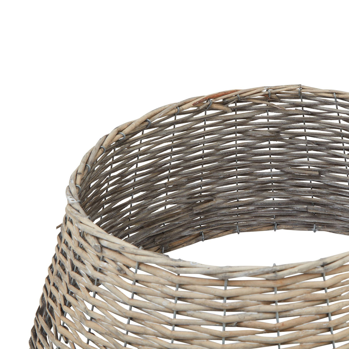 Close-up looking into the tree collar's circular opening, with the curved rim, darker inner weave and visible support grid.