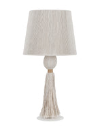 Unlit cream table lamp with a corded tapered shade, rounded wrapped stem and long tassel above a white circular foot.
