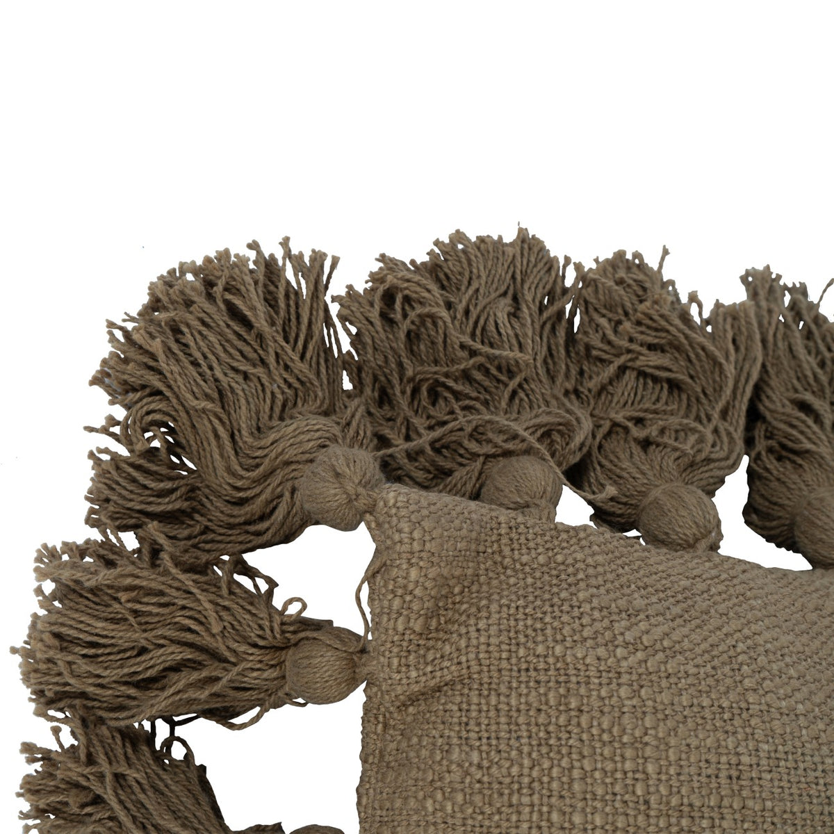 Close-up of a cushion corner, showing the textured weave and loose yarn tassels attached around the edges.