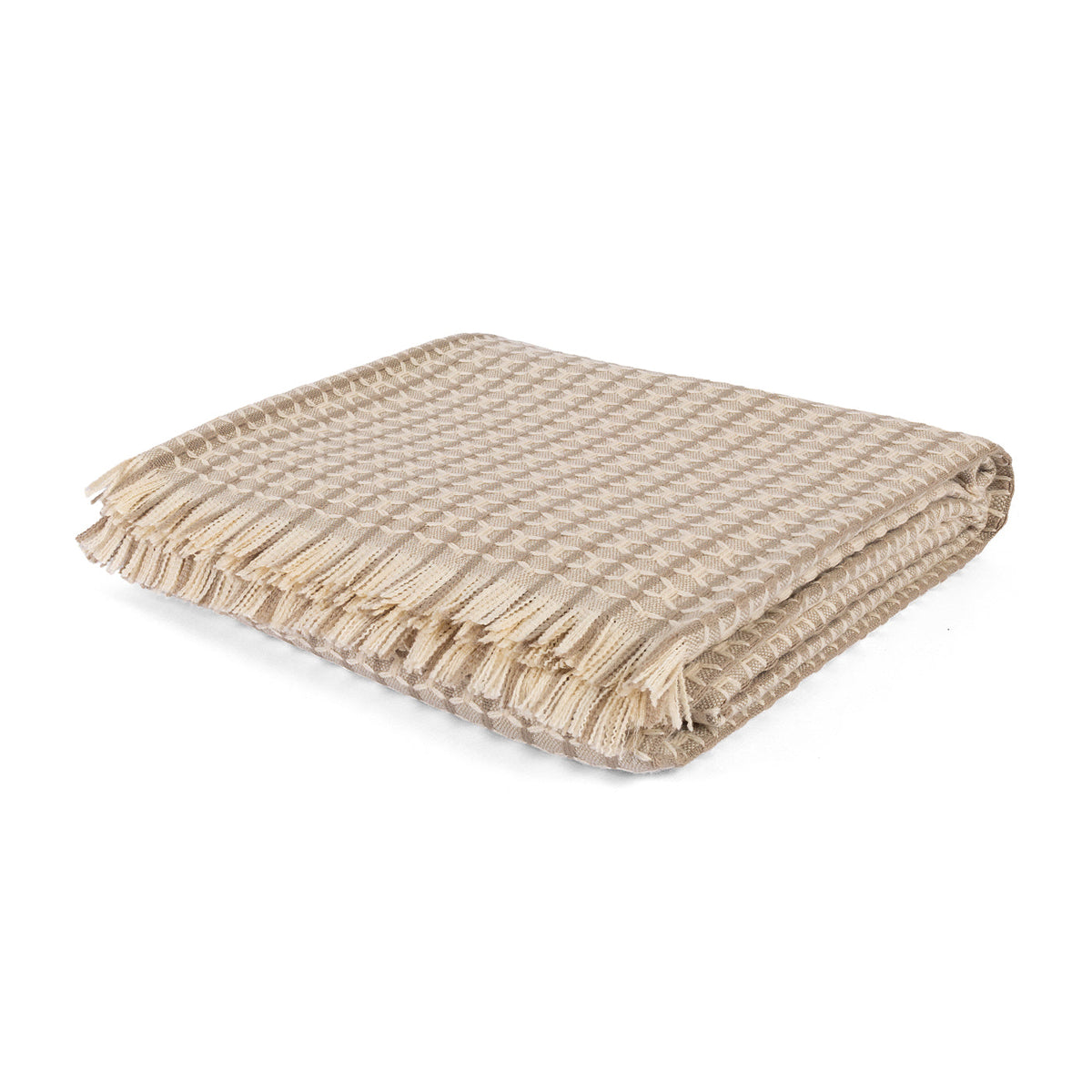 Folded Tavro Weave Throw in neutral beige with a tasseled edge on a white background