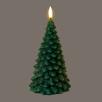 Dark-green tree-form LED candle photographed with its flame-shaped tip glowing against a grey background.