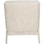 Rear view of the Teddy chair with a fully upholstered back bordered by pale wooden uprights.