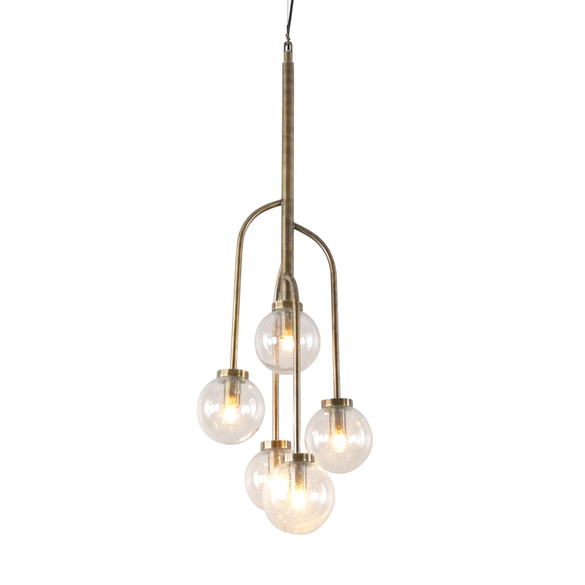 Tellurian pendant light illuminated against white, with five clear glass globes at staggered heights on curved antique brass finish arms.