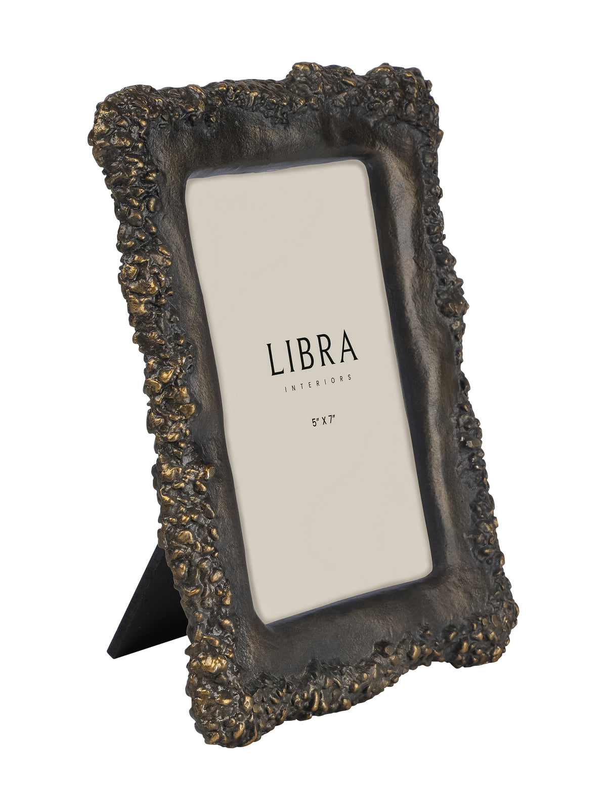 Angled view of a dark photo frame with a heavily textured irregular edge, warm metallic highlights, a cream insert and a rear tabletop support.