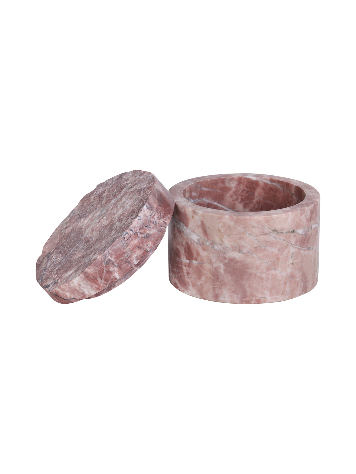 Pink marble storage jar open with its textured lid leaning beside it, showing the circular interior and thick rim.