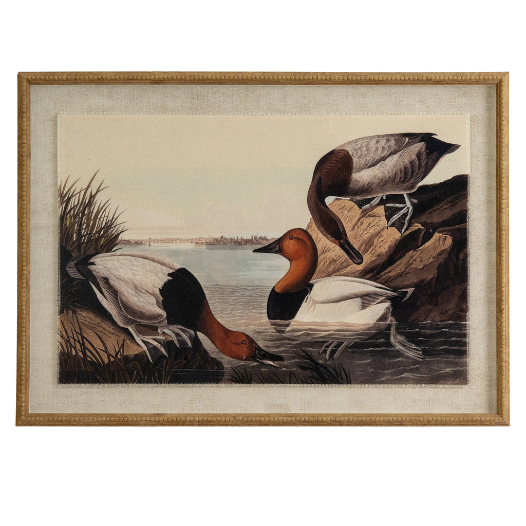 Front view of the framed print showing three brown, black and pale ducks at the water's edge, within a pale surround and tan-gold beaded frame.