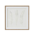Front view of square framed artwork with three pale feather forms on a textured white background, a wide white mount and beige beaded frame.