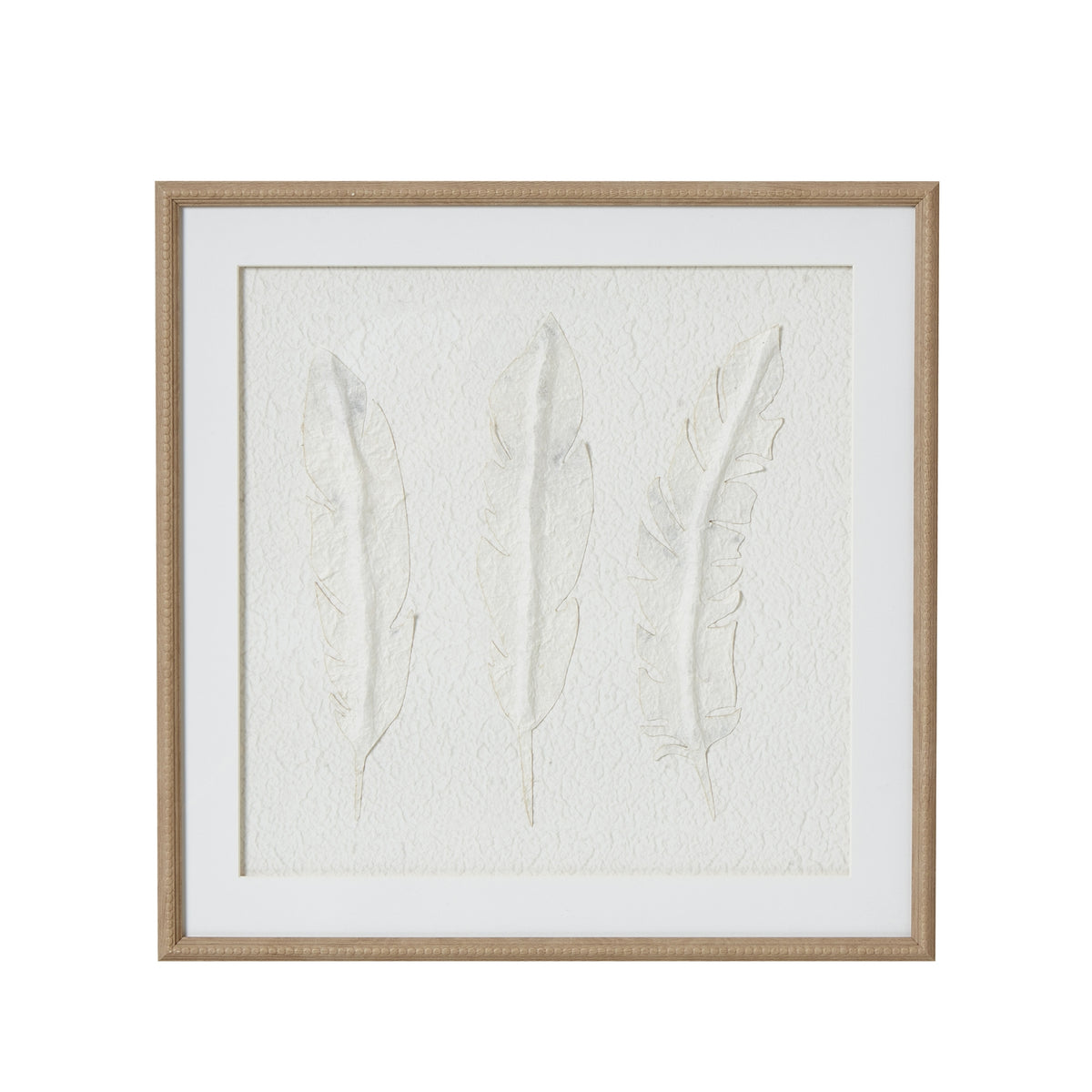 Front view of square framed artwork with three pale feather forms on a textured white background, a wide white mount and beige beaded frame.