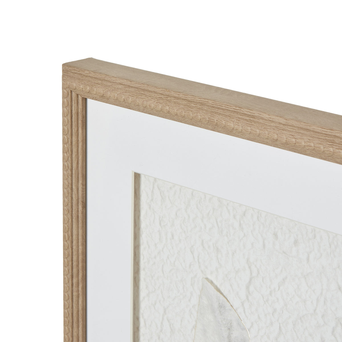 Angled close-up of the artwork's upper-left frame corner, showing the warm-beige beaded border and broad white mount.
