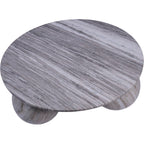 View from above showing bands of grey and pale marble across the circular tabletop, with rounded feet visible below.